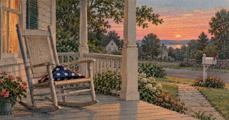 A folded American flag resting on an empty rocking chair on a small-town front porch at sunset, with the mailbox flag raised